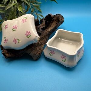 Irice porcelain lidded trinket box. Off-white w/pink &green flowers, gold rim.